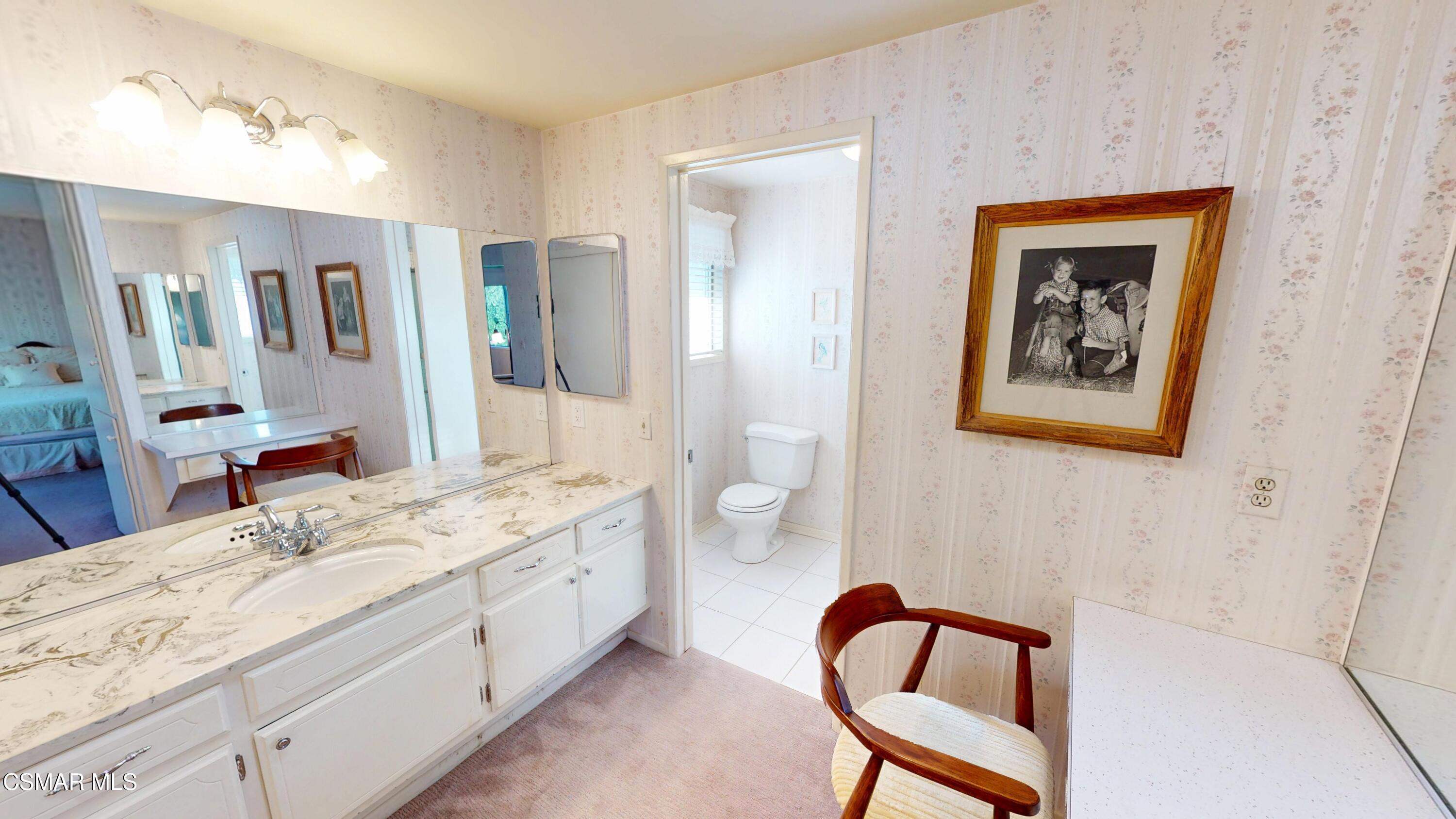 10900 Des Moines Avenue Porter Ranch, CA 91326 - Photo 29 of 38 a spacious bathroom with a double vanity sink and a mirror