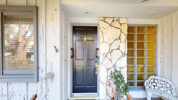 a view of entryway with wooden walls and door