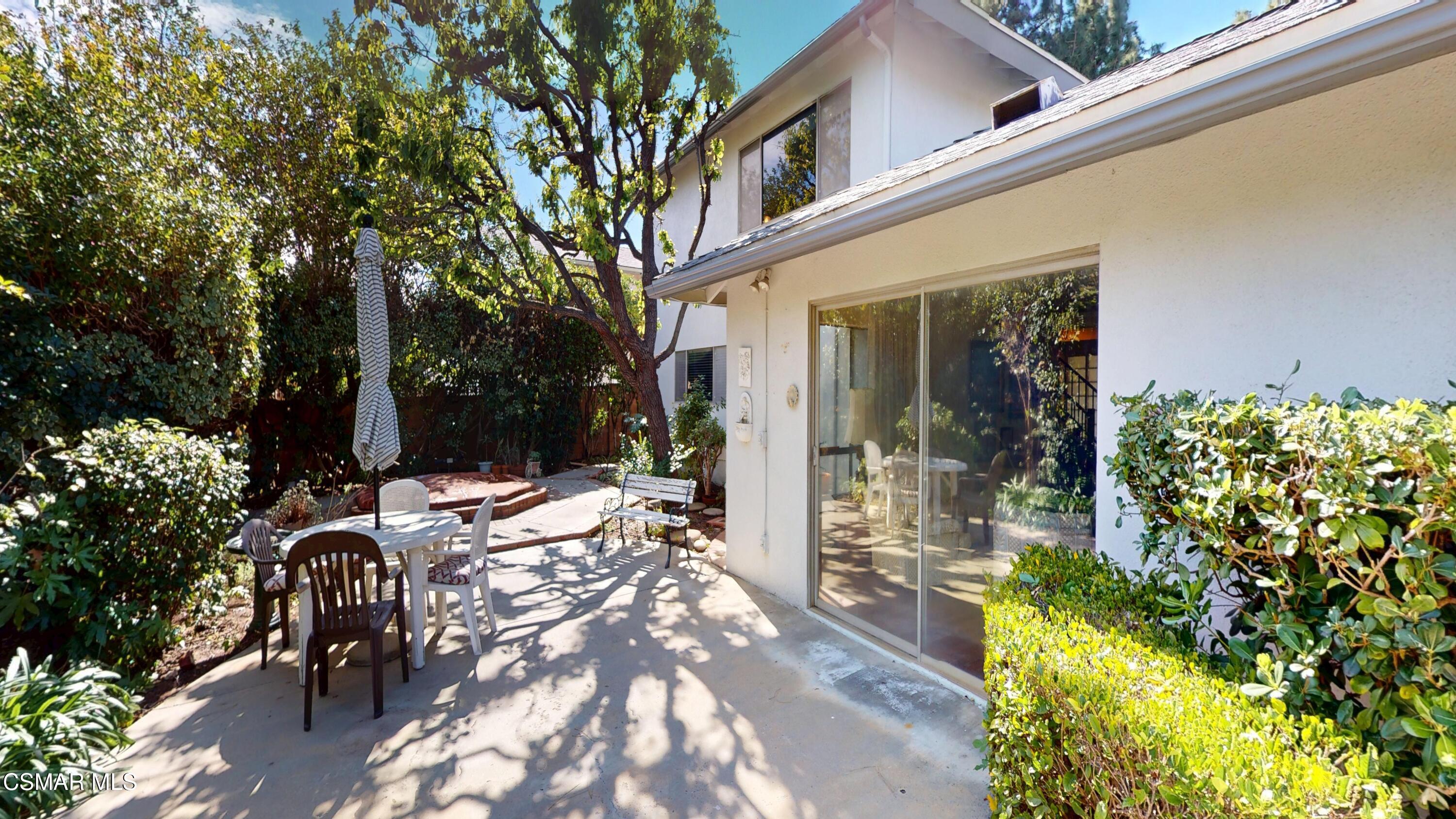10900 Des Moines Avenue Porter Ranch, CA 91326 - Photo 34 of 38 a view of a patio with table and chairs and potted plants