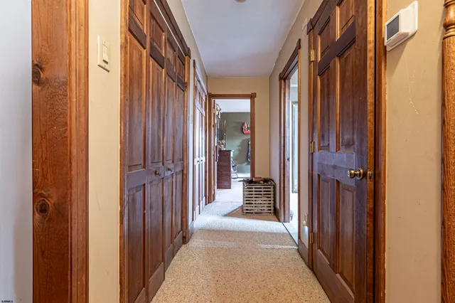 a view of a hallway with a wooden door