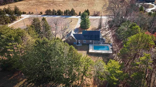 a aerial view of a house with a yard and lake view