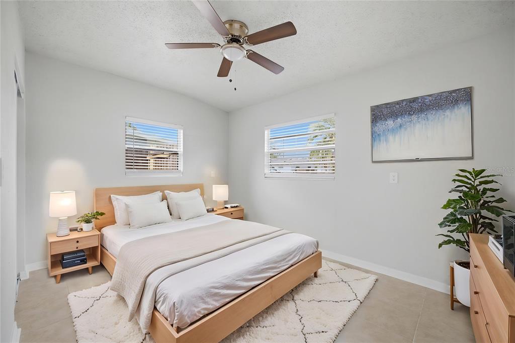 6629 Sierra Terrace New Port Richey, FL 34652 - Photo 12 of 30 a bedroom with a bed and a potted plant