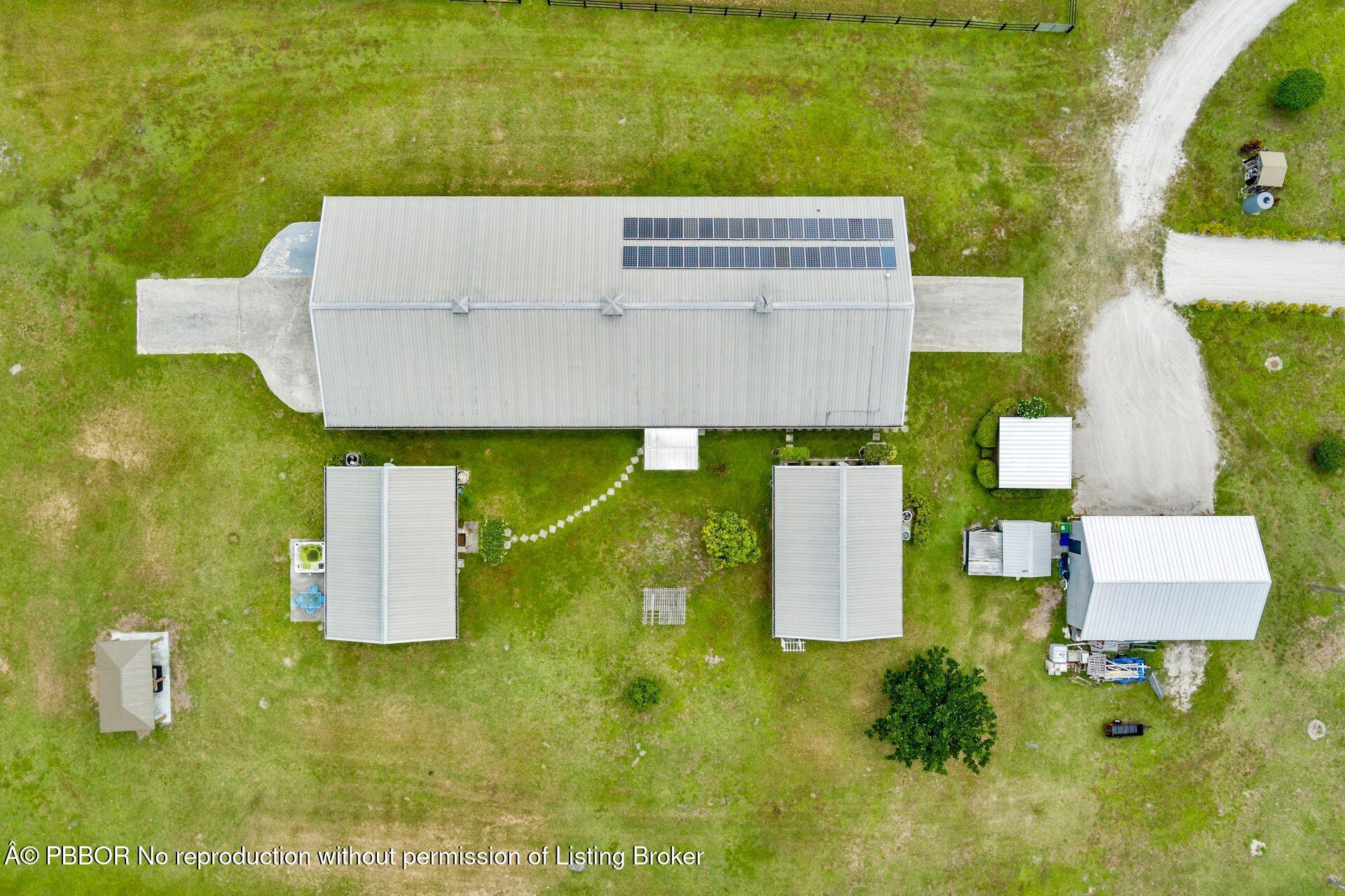 2770 E Road Loxahatchee, FL 33470 - Photo 2 of 51 an aerial view of residential house with outdoor space and parking