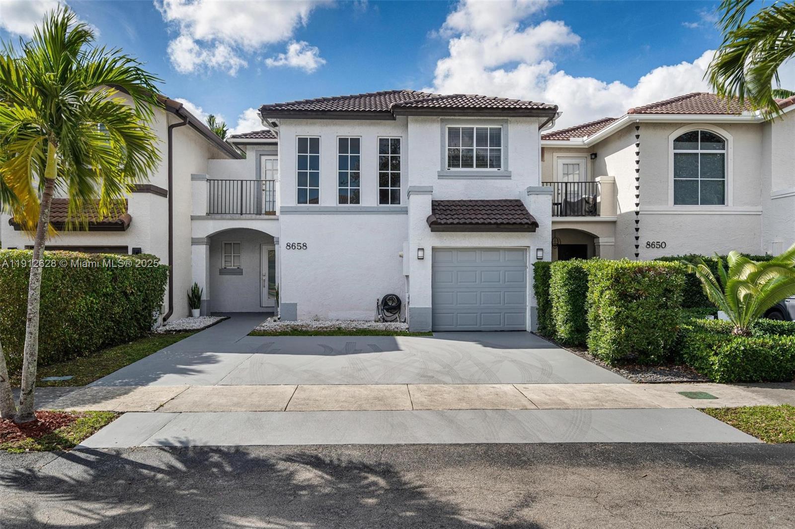 8658 Southwest 159th Court Miami, FL 33193 - Photo 1 of 30 a front view of a house with a yard and garage
