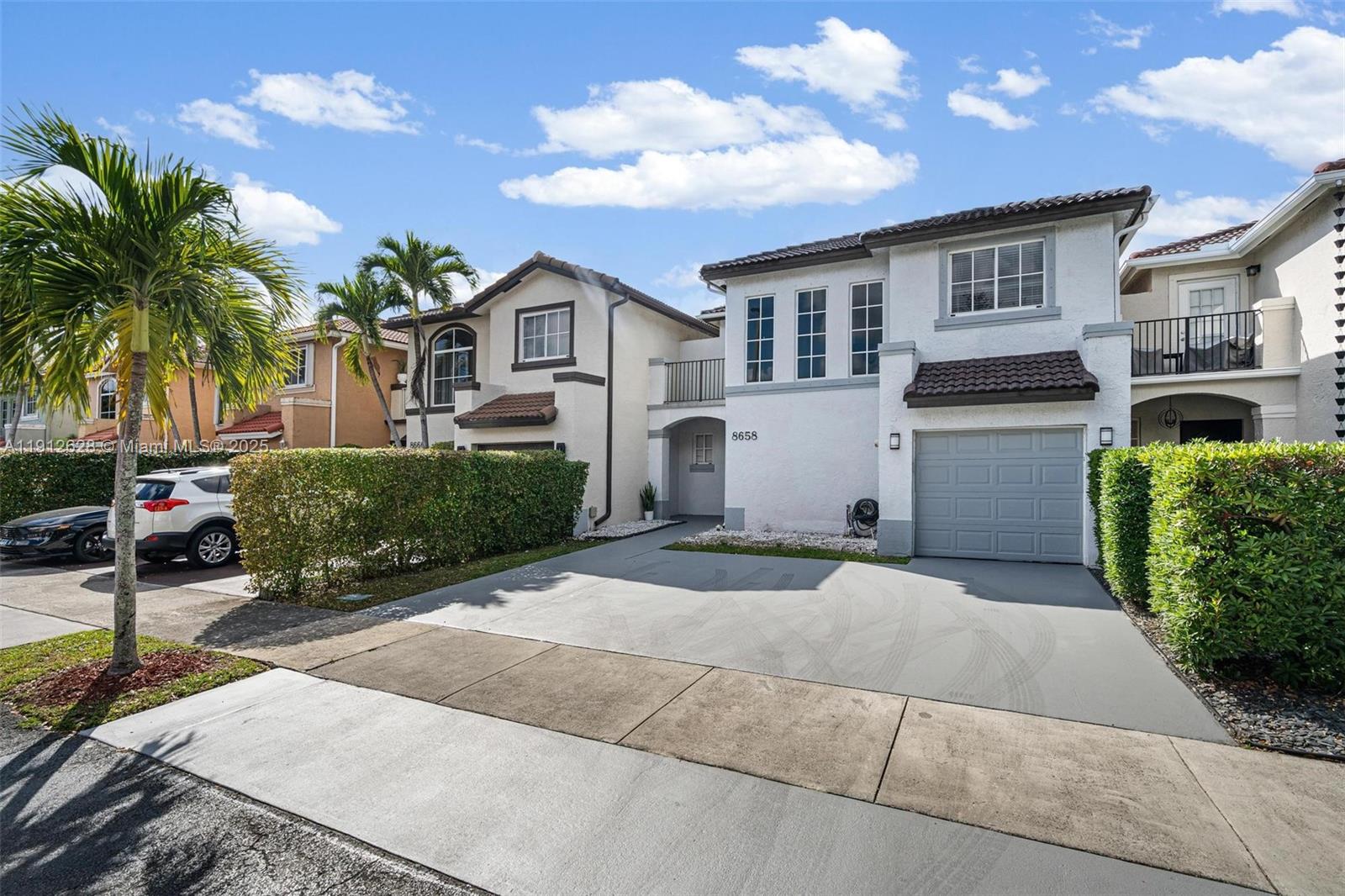 8658 Southwest 159th Court Miami, FL 33193 - Photo 2 of 30 a front view of a house with garden