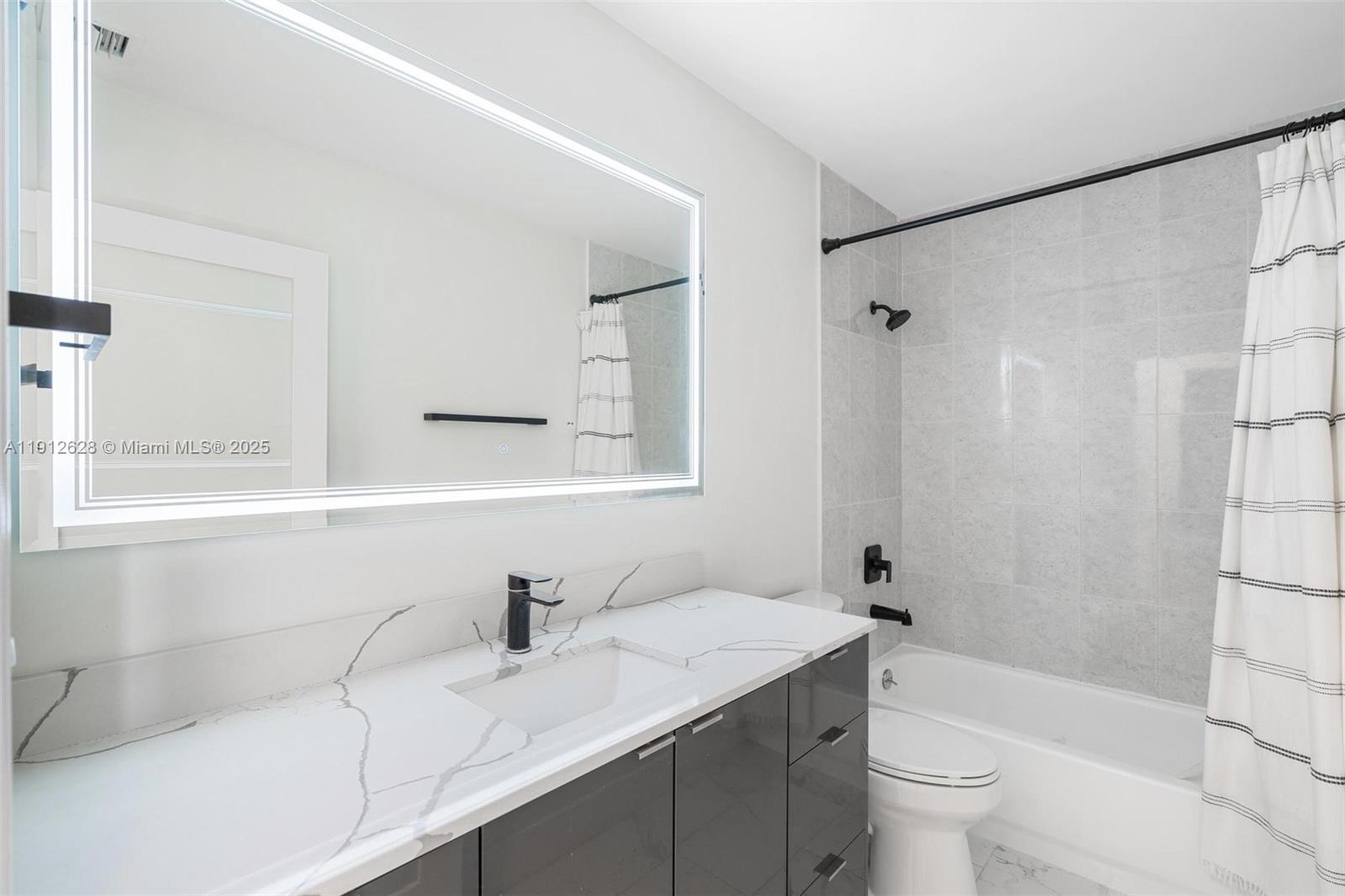 8658 Southwest 159th Court Miami, FL 33193 - Photo 21 of 30 a bathroom with a sink toilet and shower