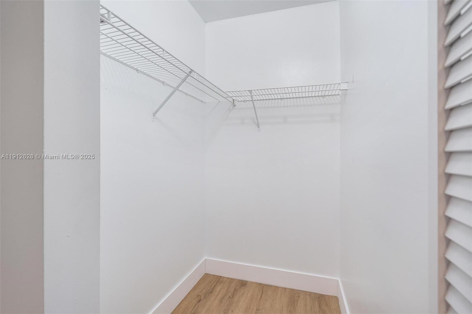 8658 Southwest 159th Court Miami, FL 33193 - Photo 23 of 30 a view of a room with racks on the wall