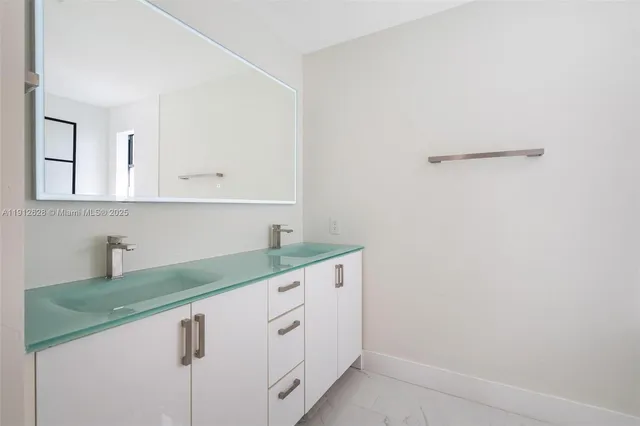 a kitchen with white cabinets