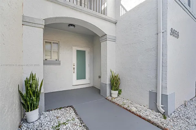 a hallway with painting and wooden floor