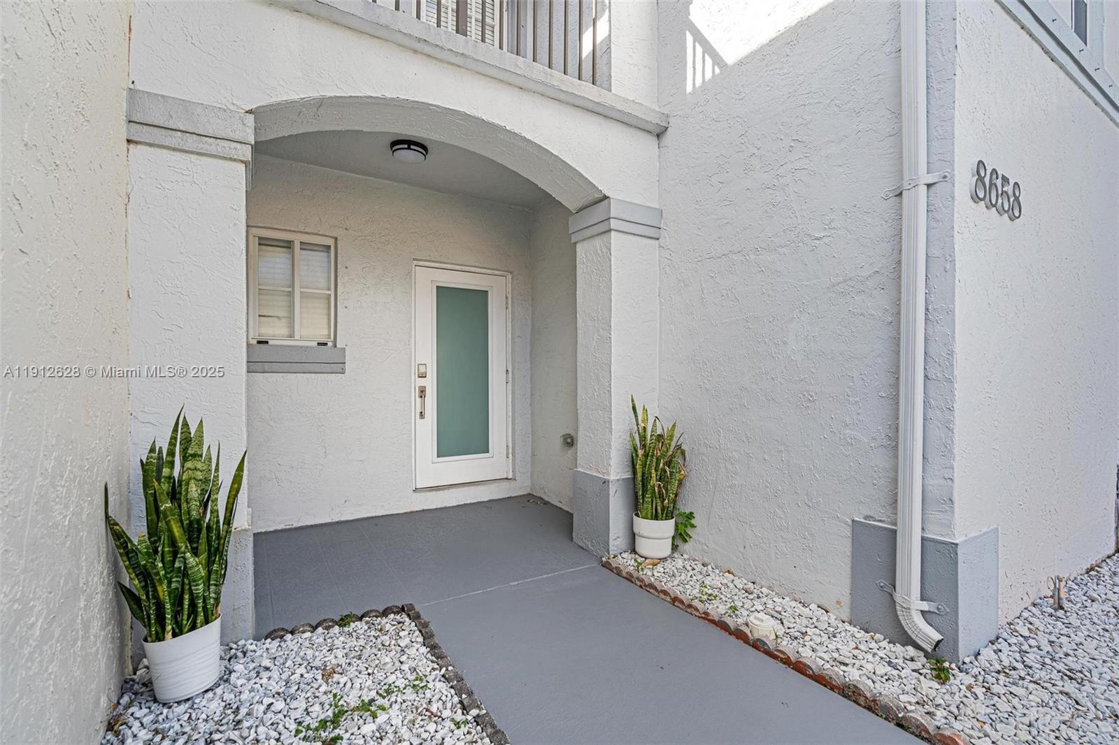 8658 Southwest 159th Court Miami, FL 33193 - Photo 3 of 30 a hallway with painting and wooden floor