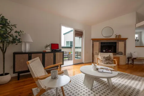 a living room with furniture a table and a fireplace