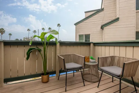 a table and chairs in patio of a house
