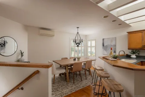 a dining hall with a dining table and chairs with wooden floor