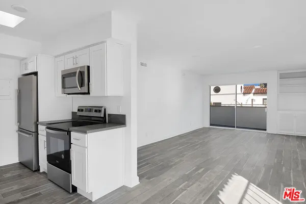 a kitchen with stainless steel appliances a stove microwave and a refrigerator