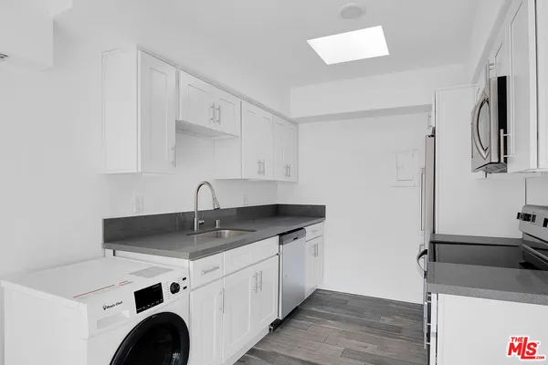 a view of cabinets a sink and dishwasher in a kitchen