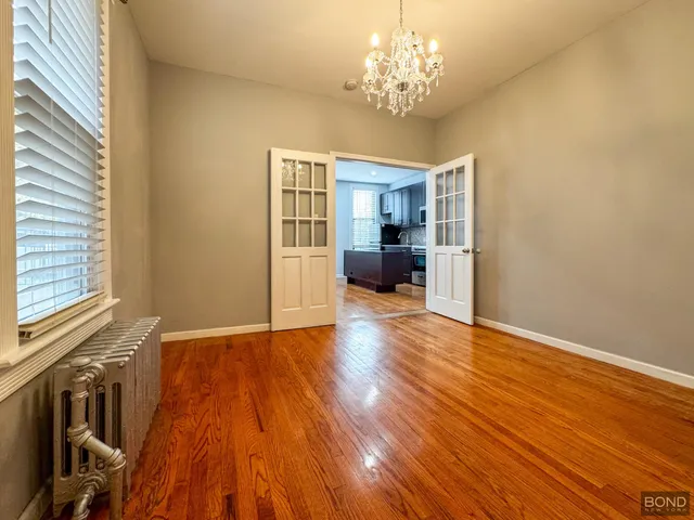 a view of livingroom with kitchen and hardwood