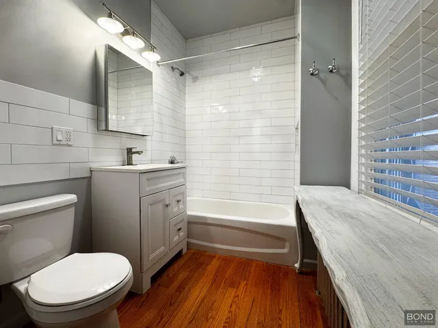 a bathroom with a granite countertop toilet a sink and bathtub