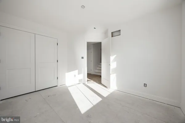 an empty room with a empty space and windows