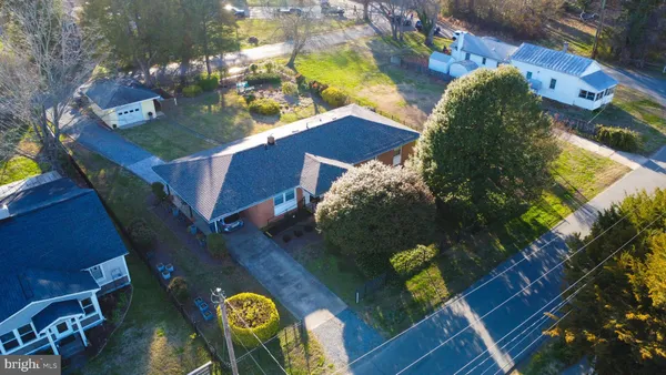 a view of swimming pool with seating area and yard in the back