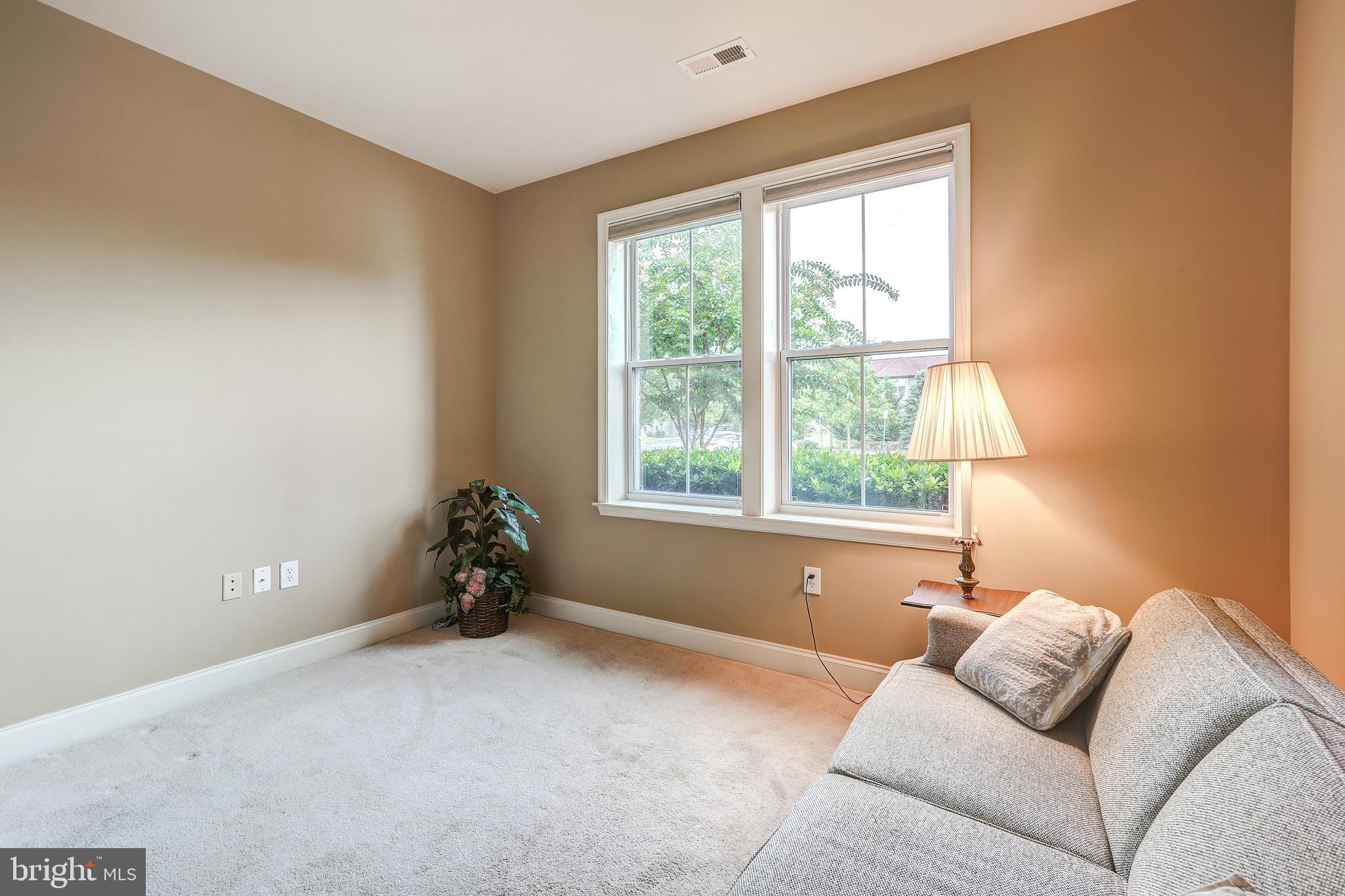 3030 Mill Island Parkway, Unit 109 Frederick, MD 21701 - Photo 12 of 20 a living room with furniture and a window