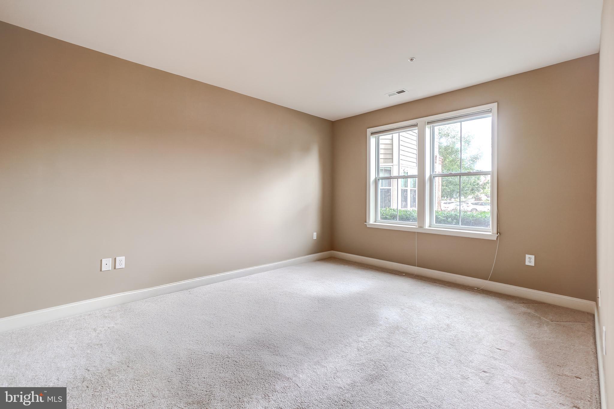 3030 Mill Island Parkway, Unit 109 Frederick, MD 21701 - Photo 14 of 20 a view of an empty room with a window