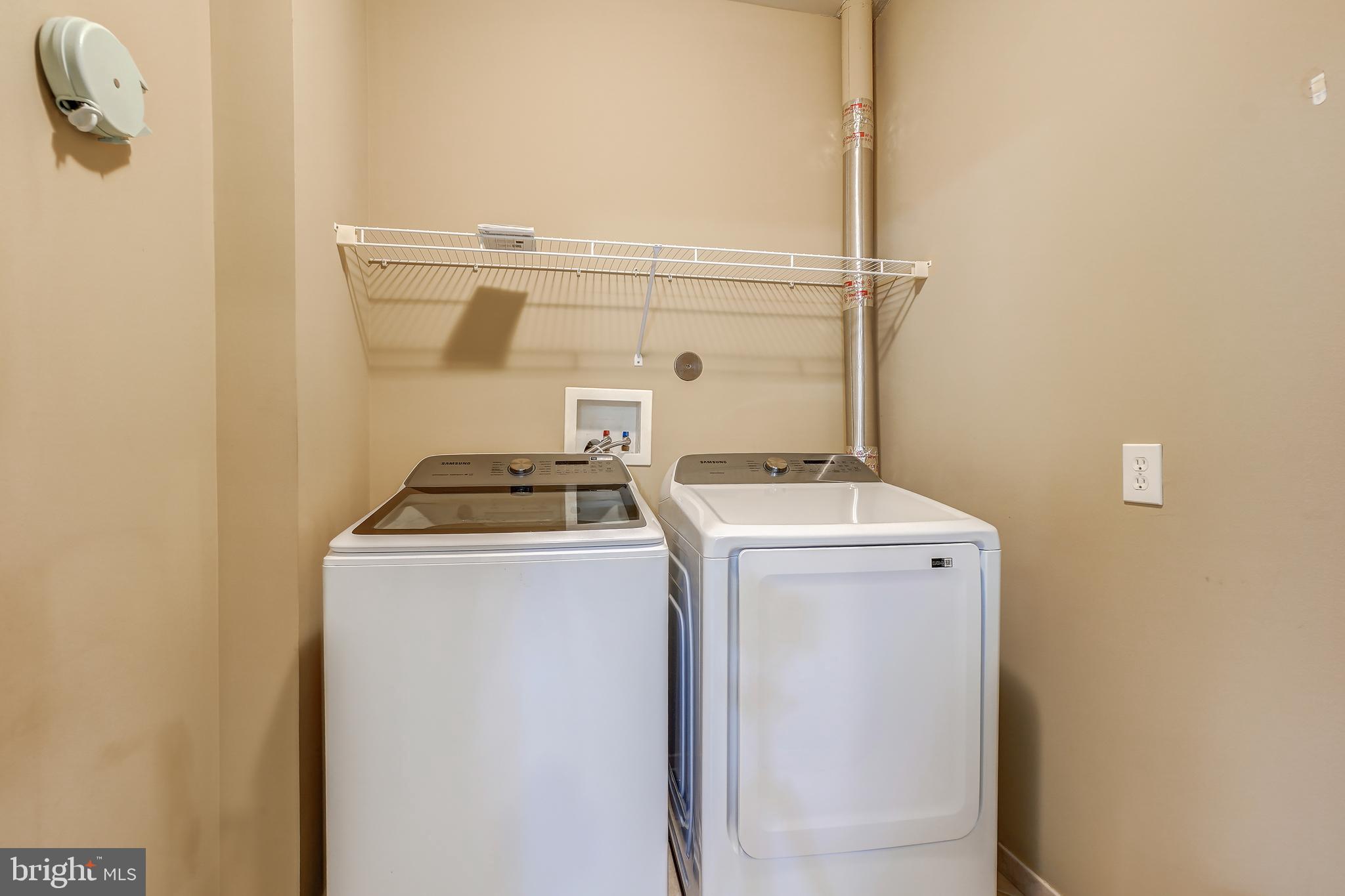 3030 Mill Island Parkway, Unit 109 Frederick, MD 21701 - Photo 16 of 20 a utility room with dryer and washer