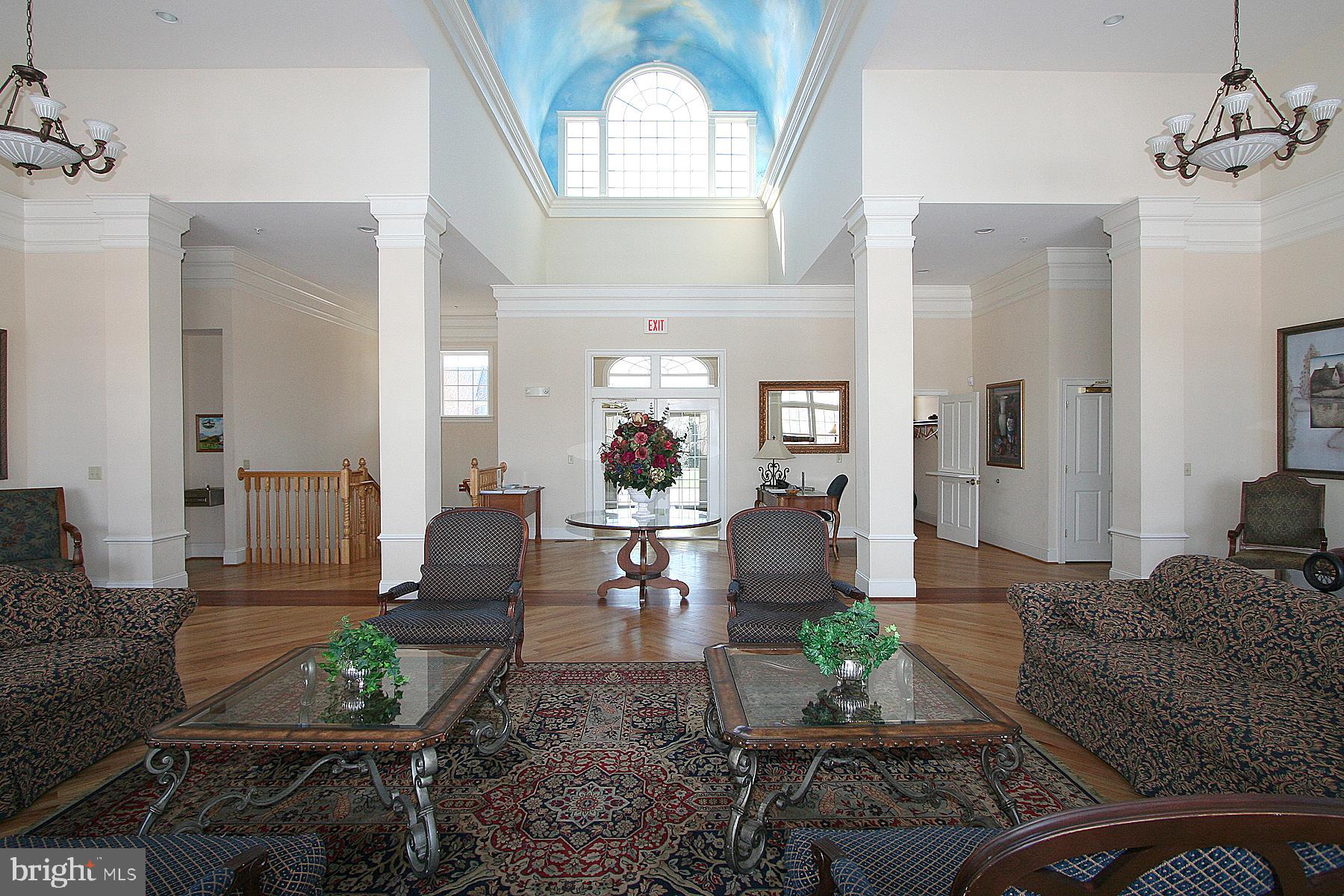 3030 Mill Island Parkway, Unit 109 Frederick, MD 21701 - Photo 17 of 20 a living room with furniture and a large mirror