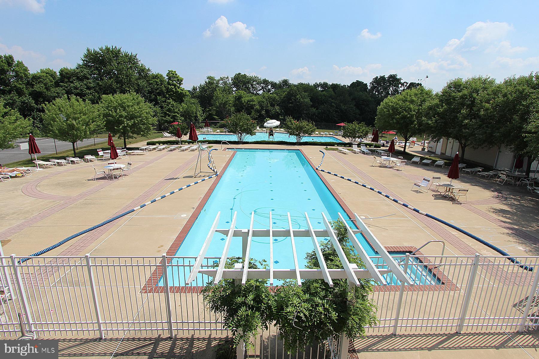 3030 Mill Island Parkway, Unit 109 Frederick, MD 21701 - Photo 18 of 20 a view of swimming pool with outdoor seating and plants