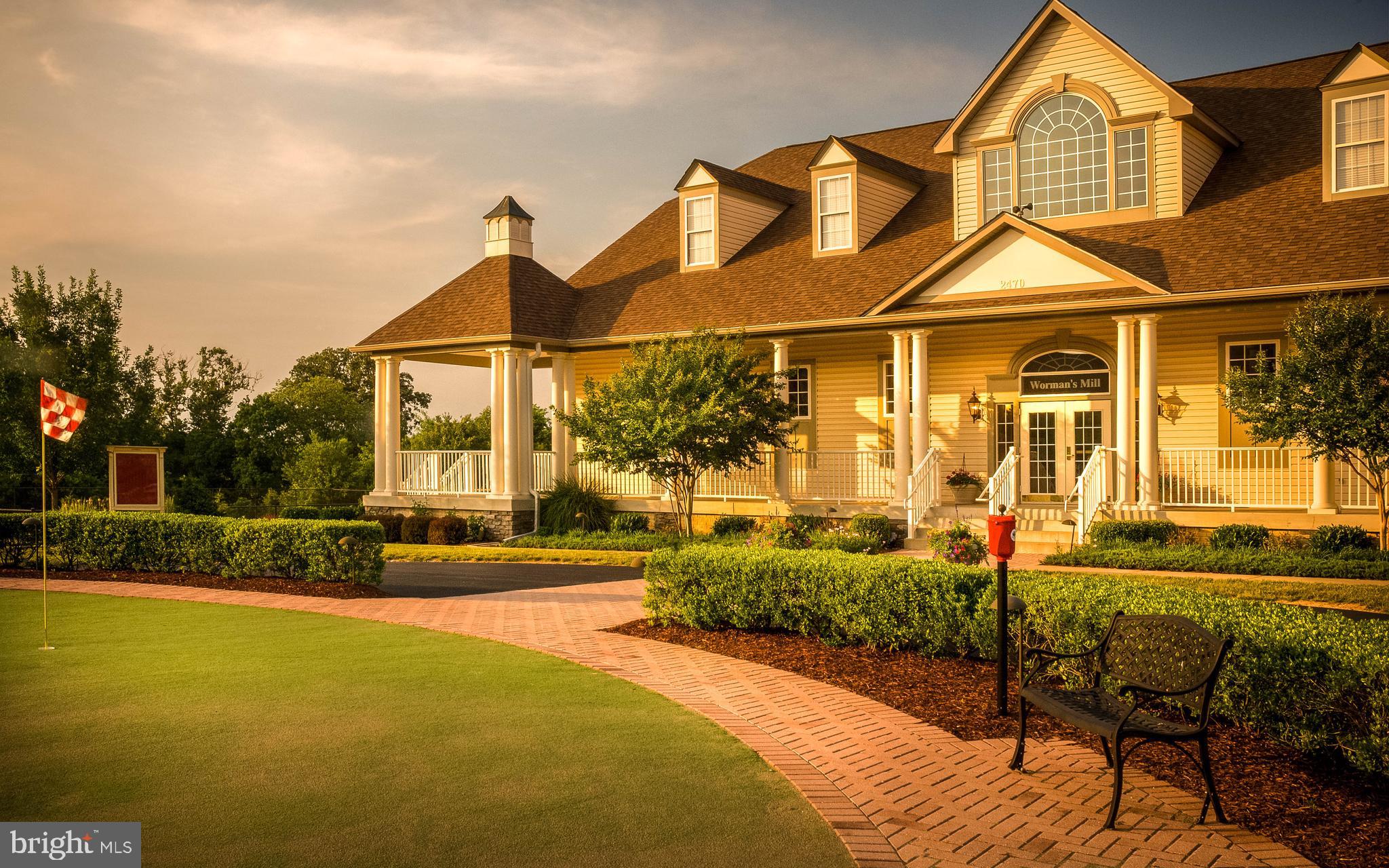 3030 Mill Island Parkway, Unit 109 Frederick, MD 21701 - Photo 19 of 20 a view of a white house with a swimming pool table and chairs