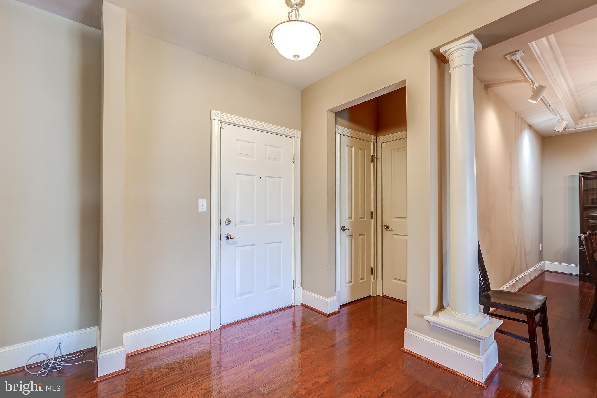 3030 Mill Island Parkway, Unit 109 Frederick, MD 21701 - Photo 4 of 20 a view of a hallway with wooden floor and front door