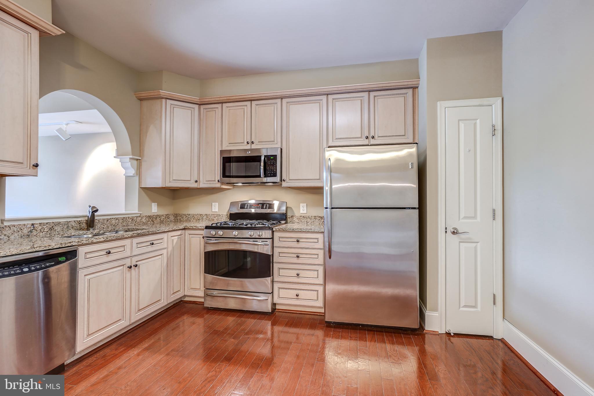 3030 Mill Island Parkway, Unit 109 Frederick, MD 21701 - Photo 5 of 20 a kitchen with a refrigerator stove top oven and sink