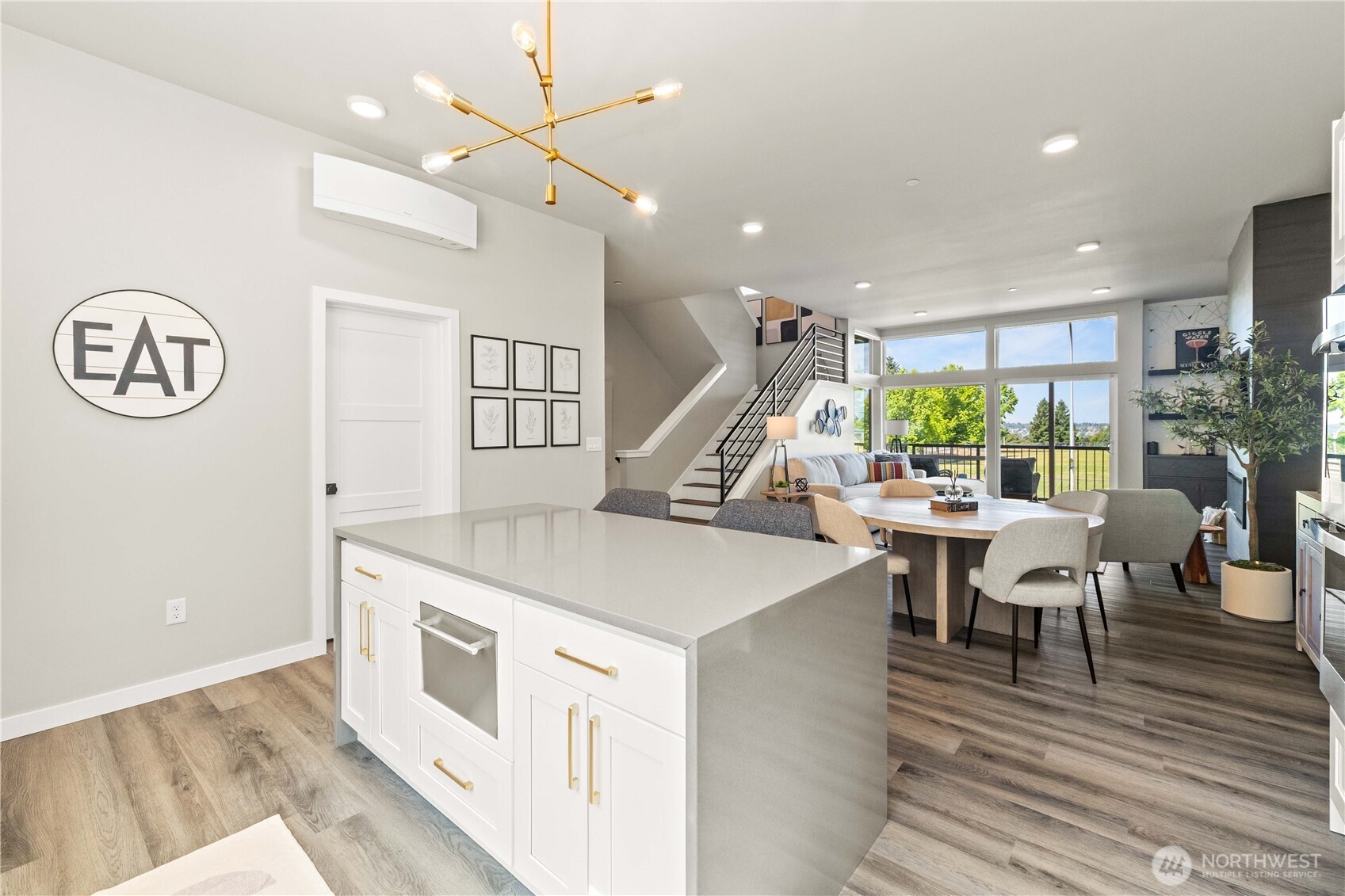 1208 Harrington Avenue Northeast Renton, WA 98056 - Photo 11 of 40 a open kitchen with a table chairs and white cabinets