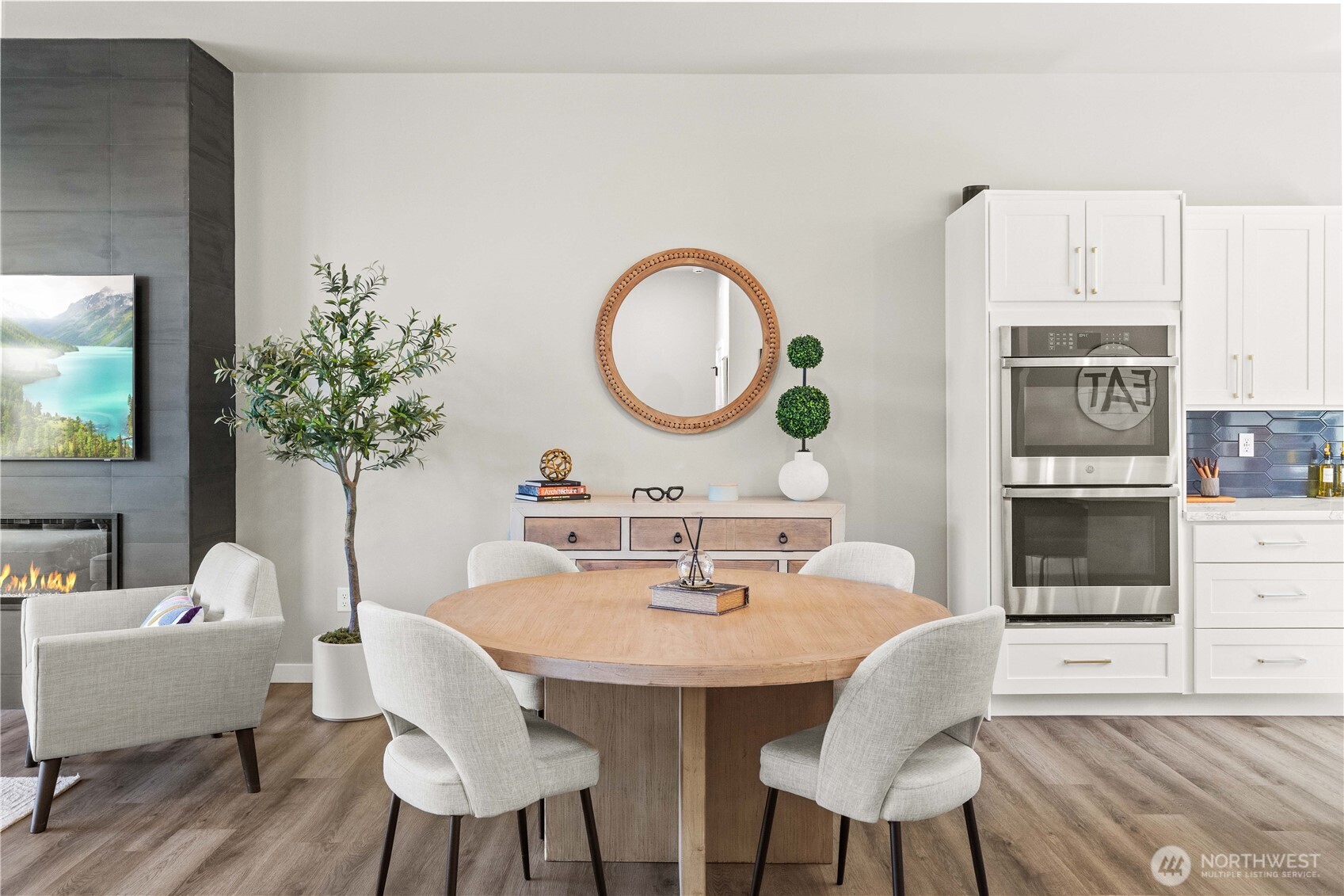1208 Harrington Avenue Northeast Renton, WA 98056 - Photo 14 of 40 a view of a dining room with furniture and wooden floor