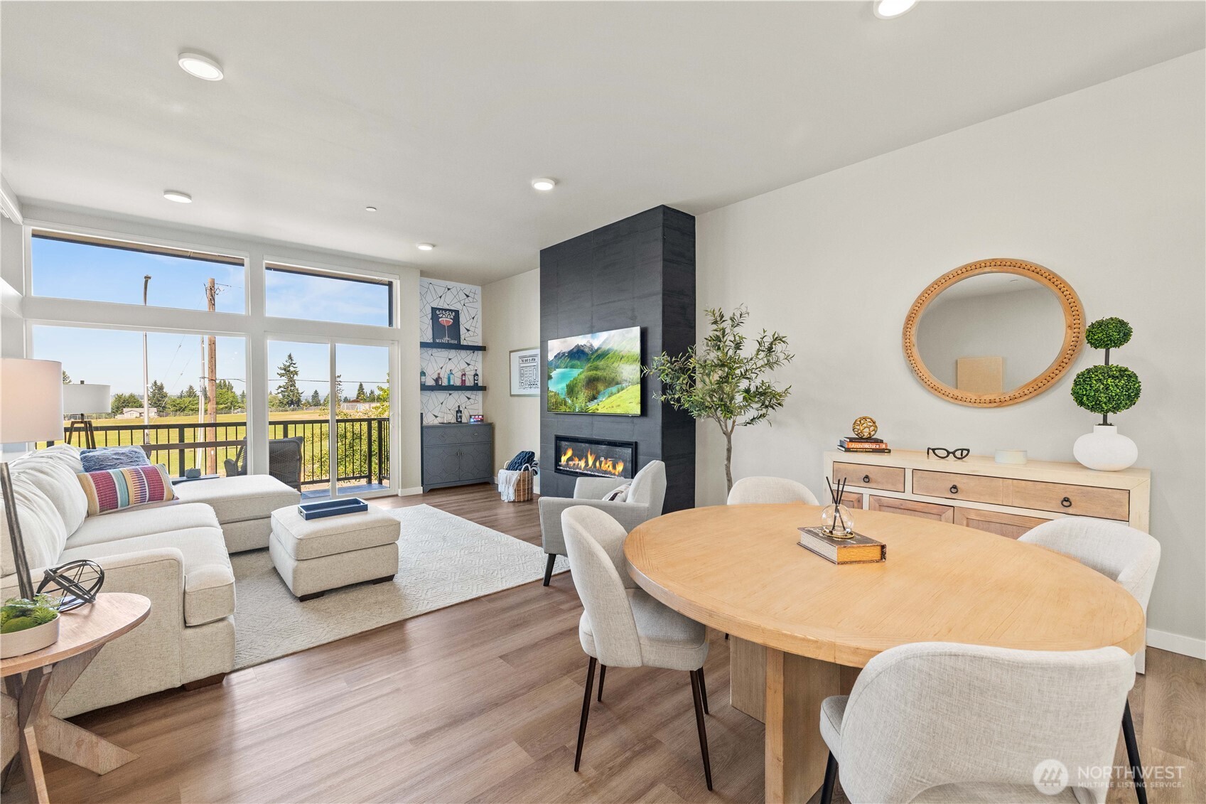 1208 Harrington Avenue Northeast Renton, WA 98056 - Photo 15 of 40 a view of a dining room with furniture a potted plant and a large window