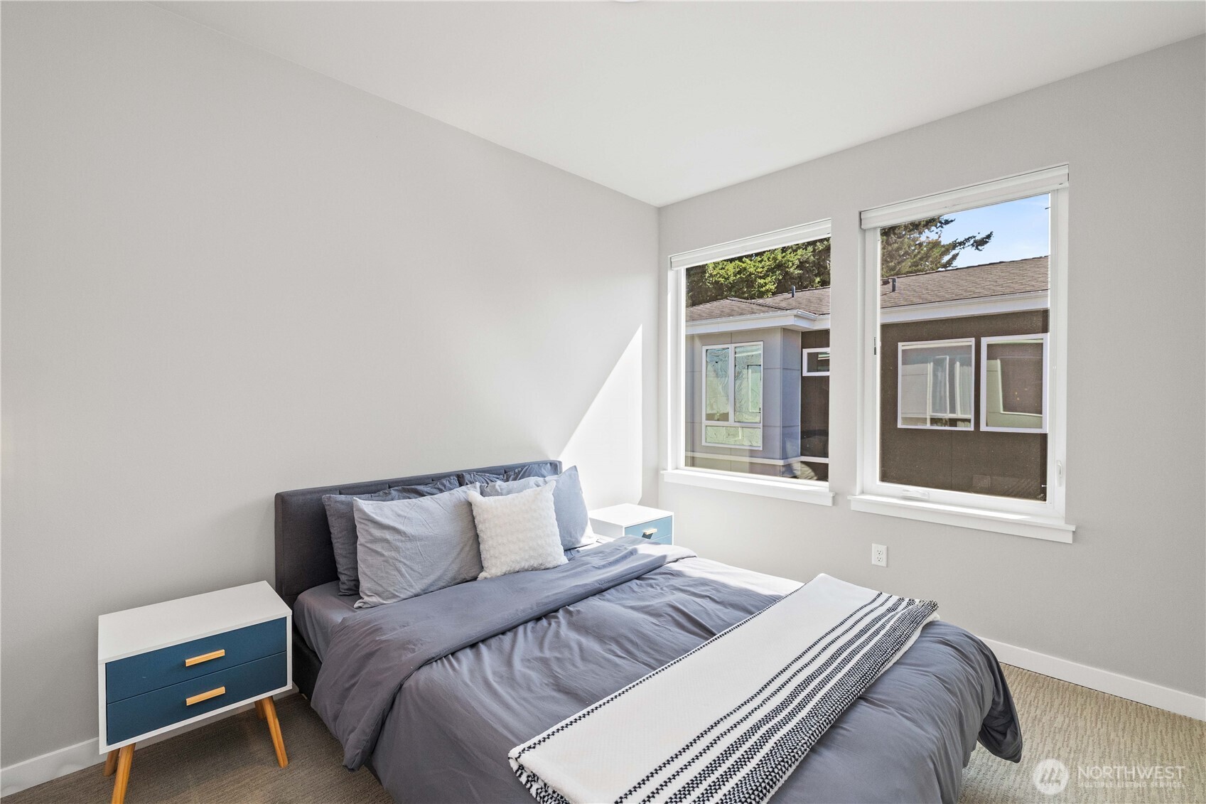 1208 Harrington Avenue Northeast Renton, WA 98056 - Photo 25 of 40 a bedroom with a bed and wooden floor