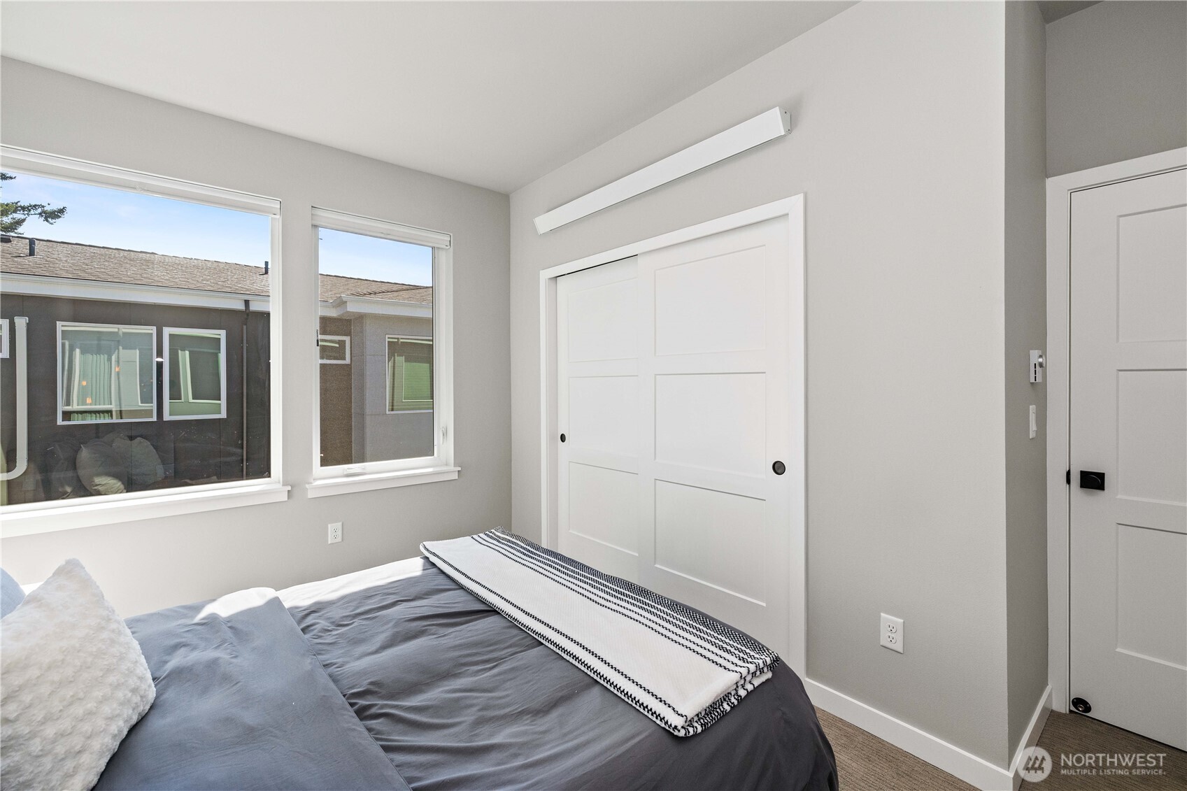 1208 Harrington Avenue Northeast Renton, WA 98056 - Photo 26 of 40 a view of a bedroom with wooden floor and windows