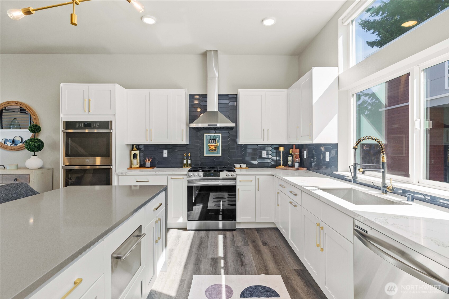 1208 Harrington Avenue Northeast Renton, WA 98056 - Photo 10 of 40 a large kitchen with stainless steel appliances lots of counter space and a sink
