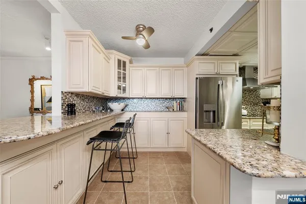 a kitchen with refrigerator and cabinets