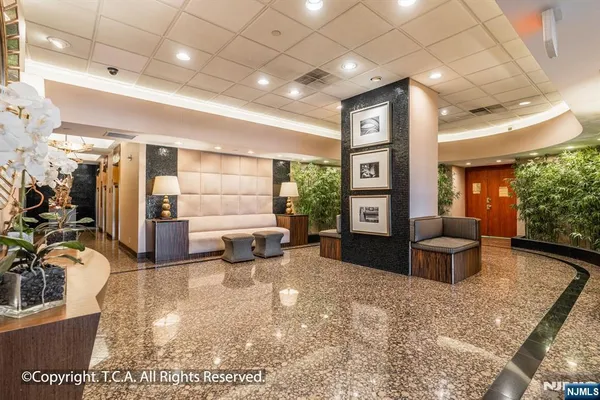 a lobby with furniture and floor to ceiling window