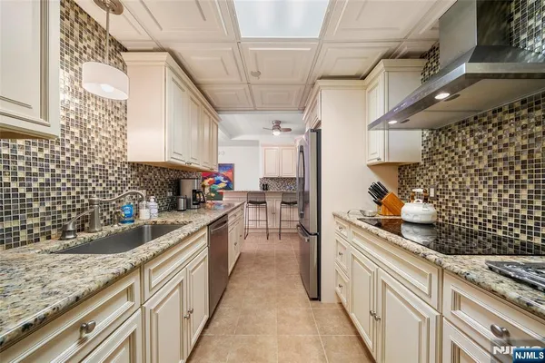 a kitchen with granite countertop cabinets and window