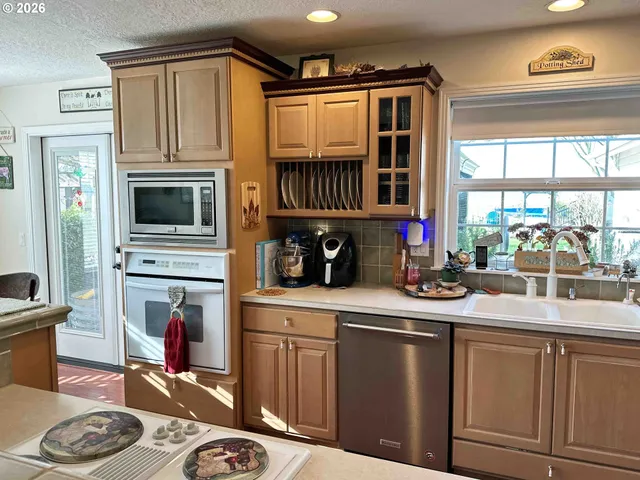 a kitchen with sink cabinets and appliances