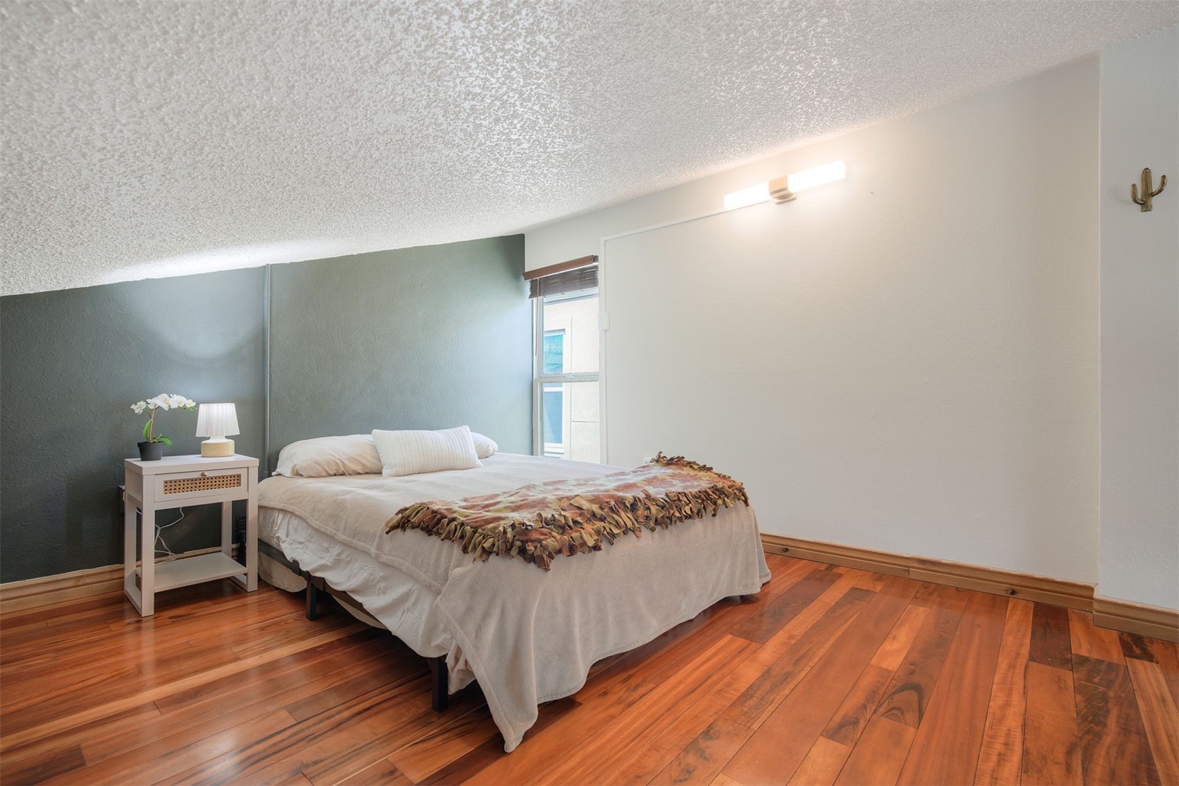 7031 Ryan Gulch Road, Unit 301 Silverthorne, CO 80498 - Photo 19 of 37 a bedroom with a bed and a table