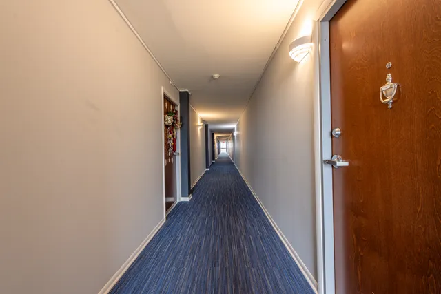 a view of hallway with wooden floor