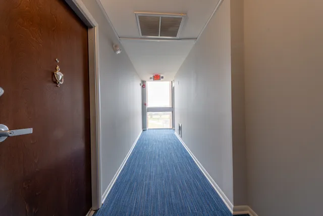 a view of hallway with wooden floor