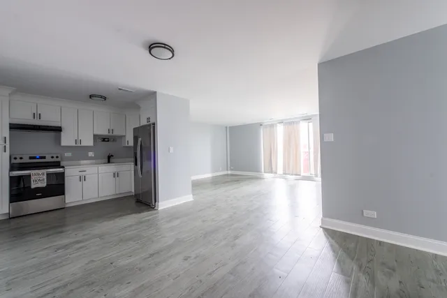 a kitchen with stainless steel appliances a refrigerator sink and cabinets