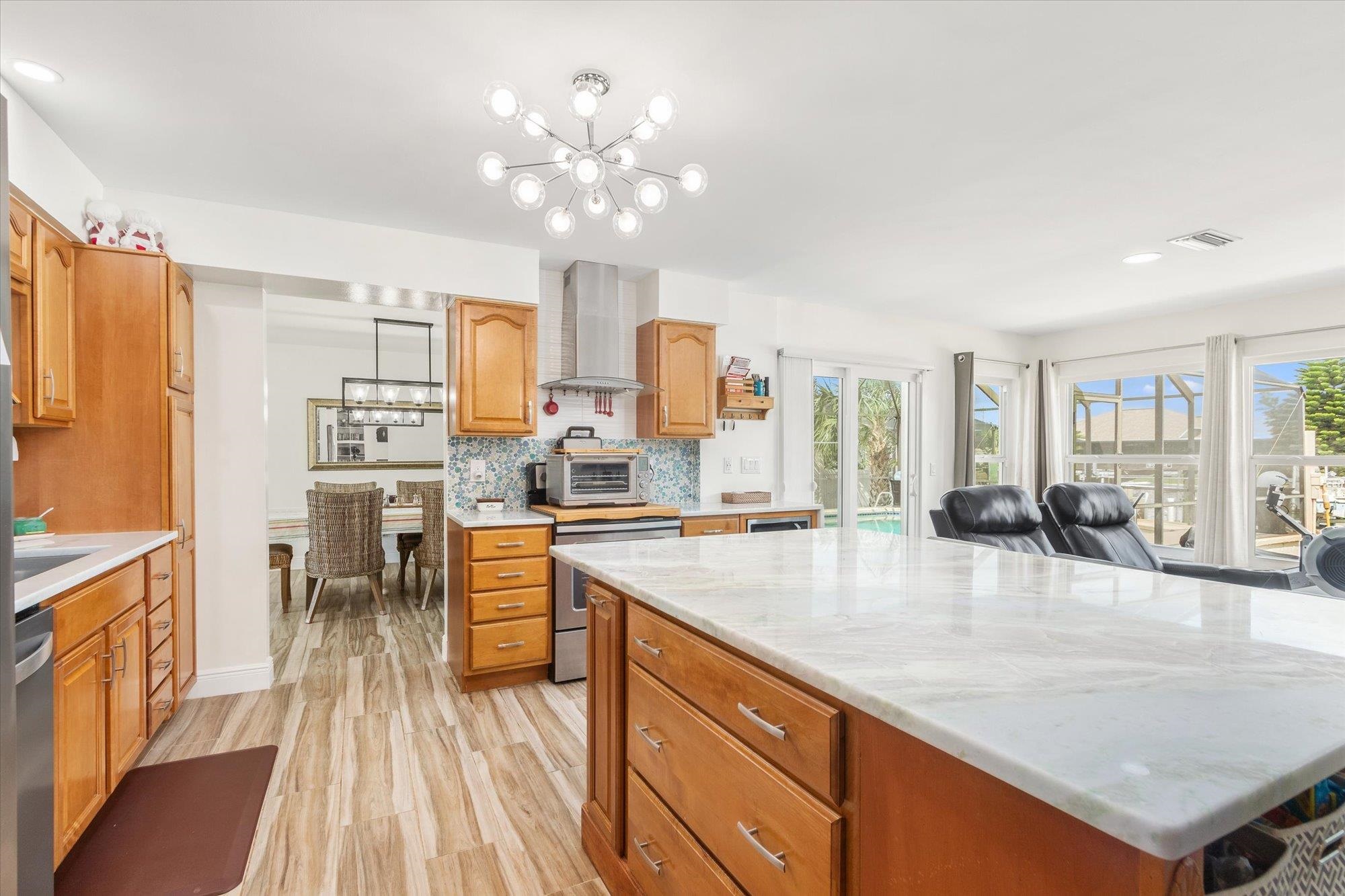 5 Cheyenne Court Palm Coast, FL 32137 - Photo 11 of 58 a large kitchen with kitchen island a large counter top appliances and cabinets