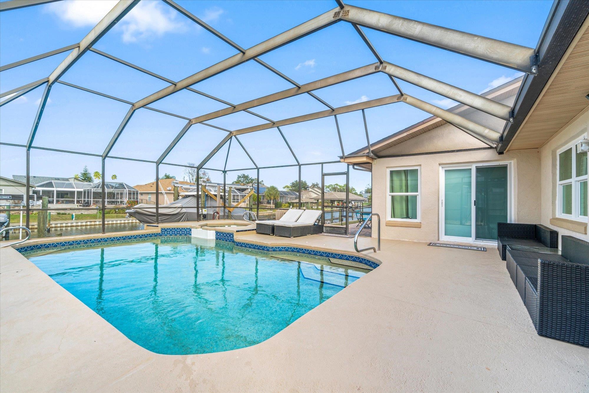 5 Cheyenne Court Palm Coast, FL 32137 - Photo 2 of 58 a view of a swimming pool with outdoor seating