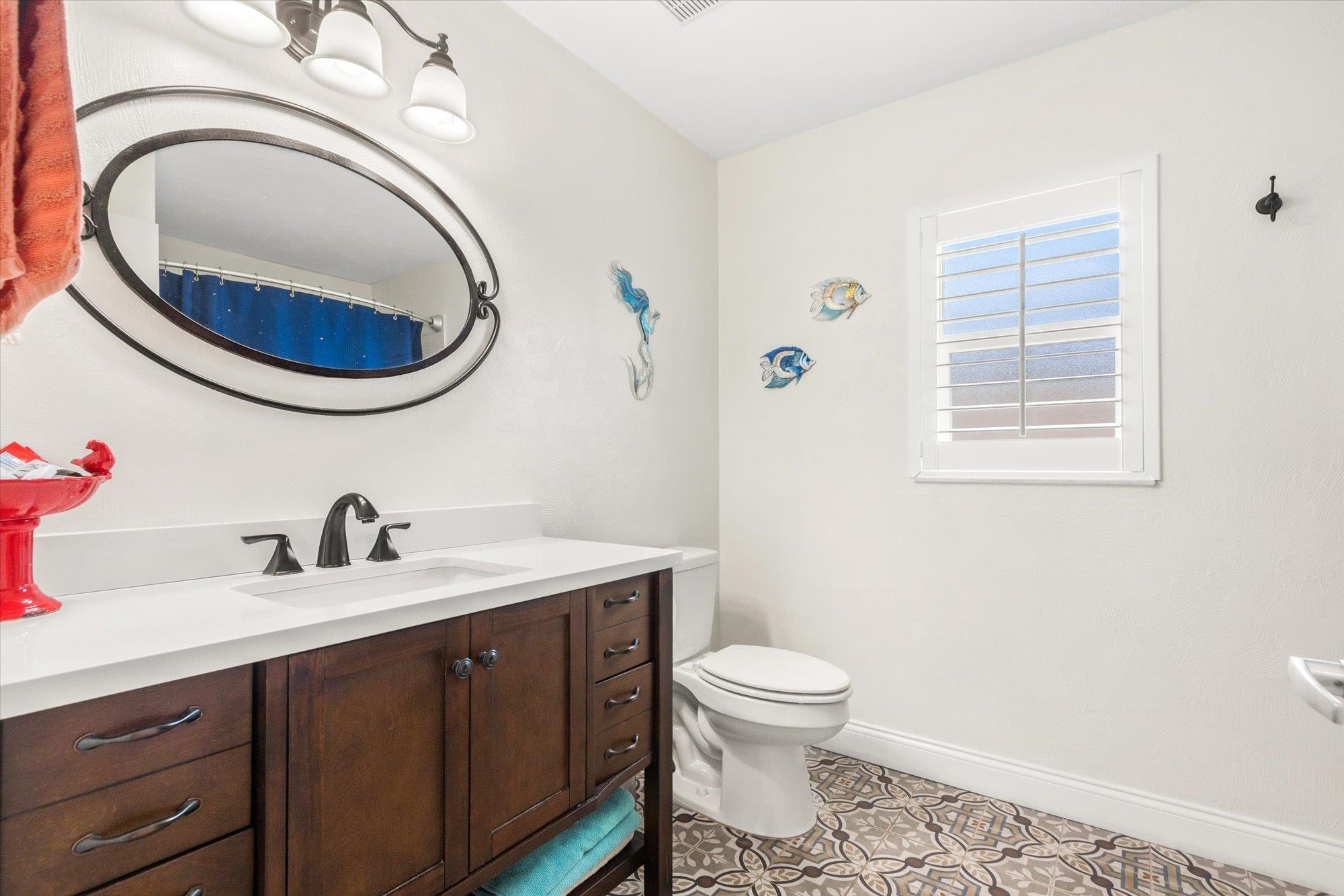5 Cheyenne Court Palm Coast, FL 32137 - Photo 30 of 58 a bathroom with a toilet a sink and mirror