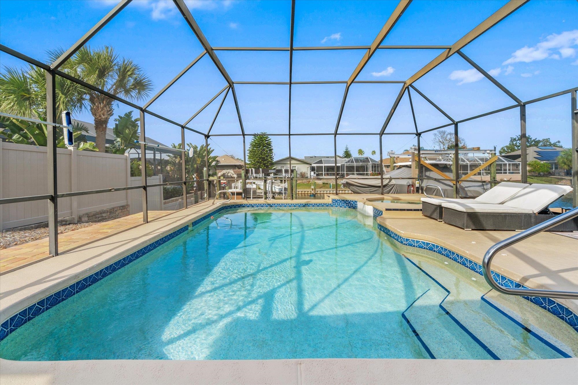 5 Cheyenne Court Palm Coast, FL 32137 - Photo 3 of 58 a view of a kitchen with kitchen island a stove a barbeque oven with a dining table and chairs