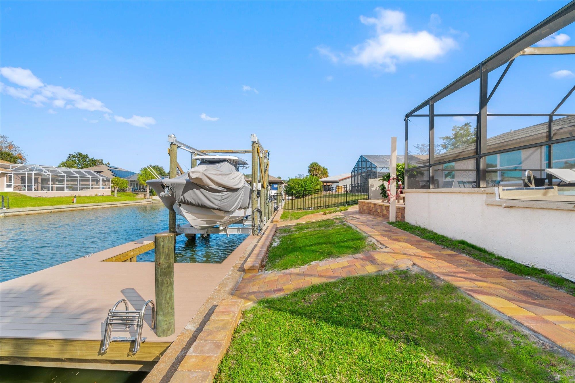 5 Cheyenne Court Palm Coast, FL 32137 - Photo 37 of 58 a view of a swimming pool with an outdoor seating and a garden